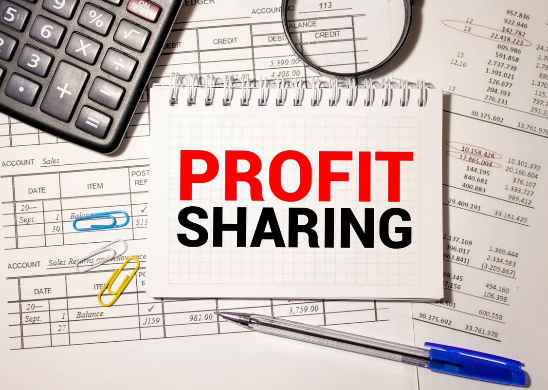 Office desk with a paper written PROFIT SHARING